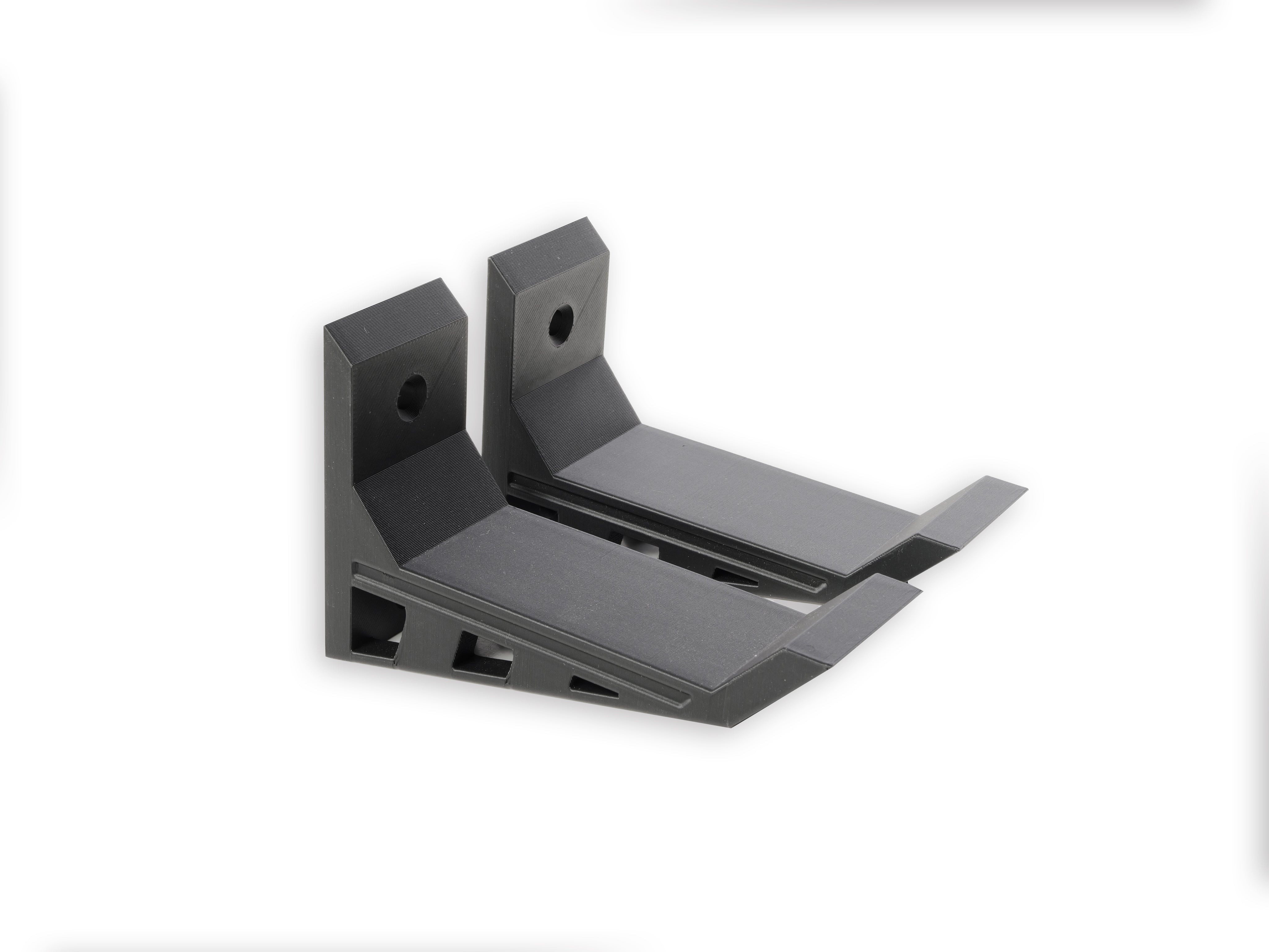 A pair of Black, Nerf wall mounts, Screw in and adhesive install,  close-up on drywall