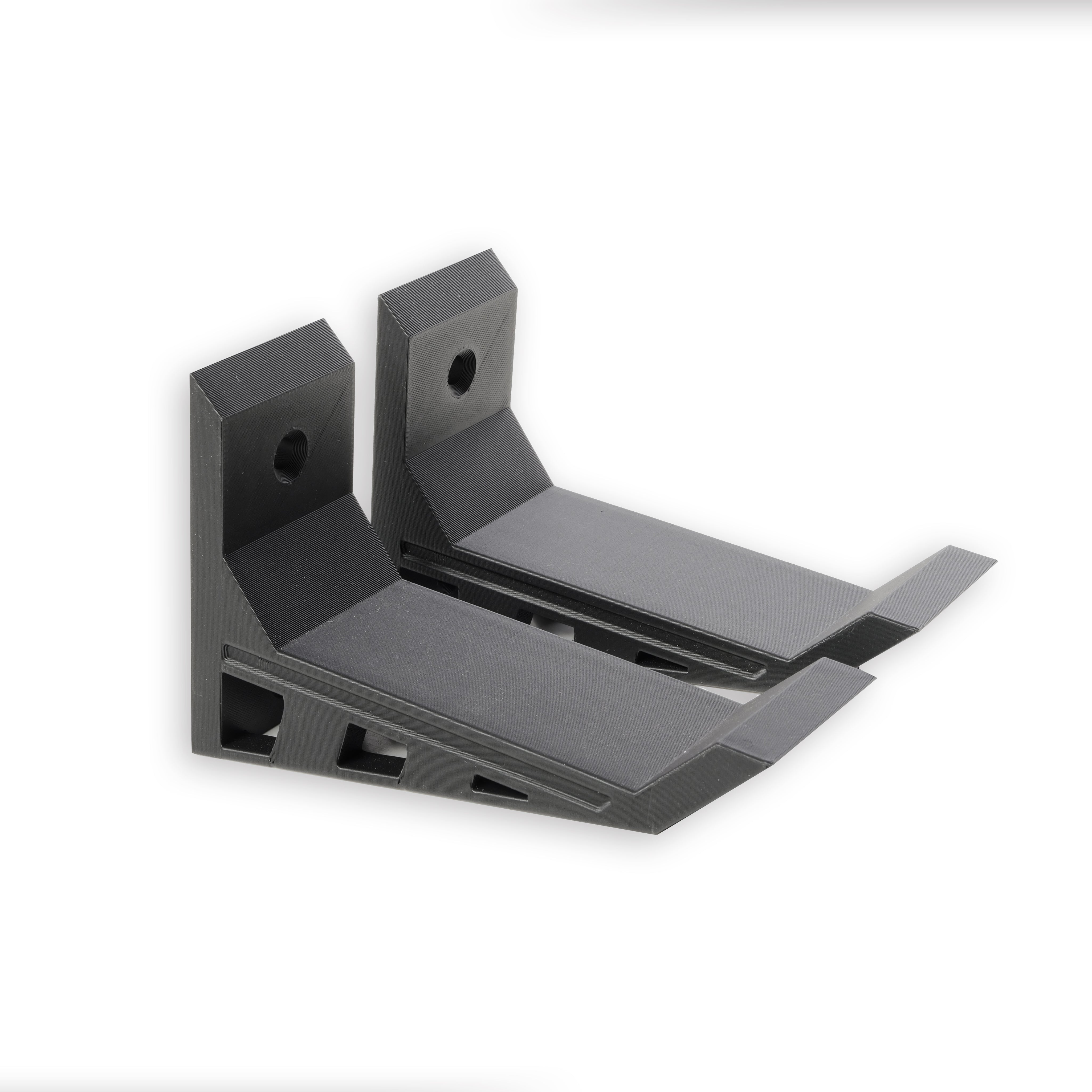 A pair of Black, Nerf wall mounts, Screw in and adhesive install,  close-up on drywall